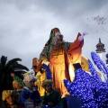 An actor dressed as Melchior, one of the Three Wise Men, throws sweets during the traditional Epiphany parade in Malaga