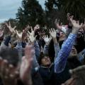 People react as sweets are thrown to them from a float by actors dressed as the Three Wise Men during the traditional Epiphany parade in Malaga